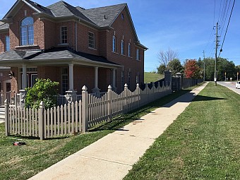 Tan scallop picket fence with gothic cap