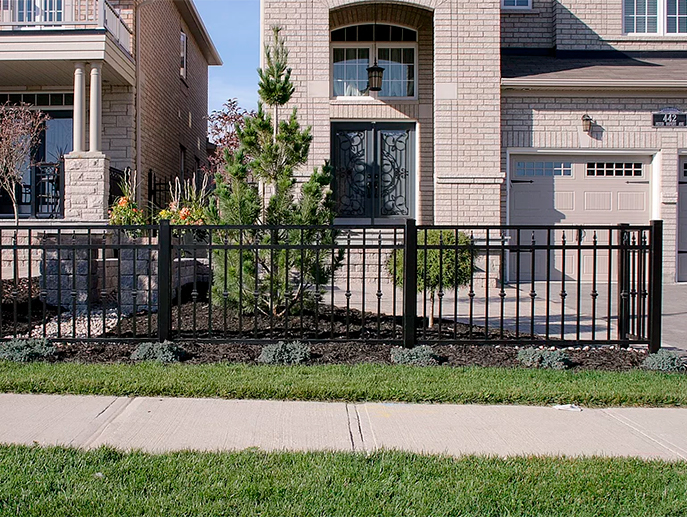 Vinyl fence installed around front yard garden of Toronto home