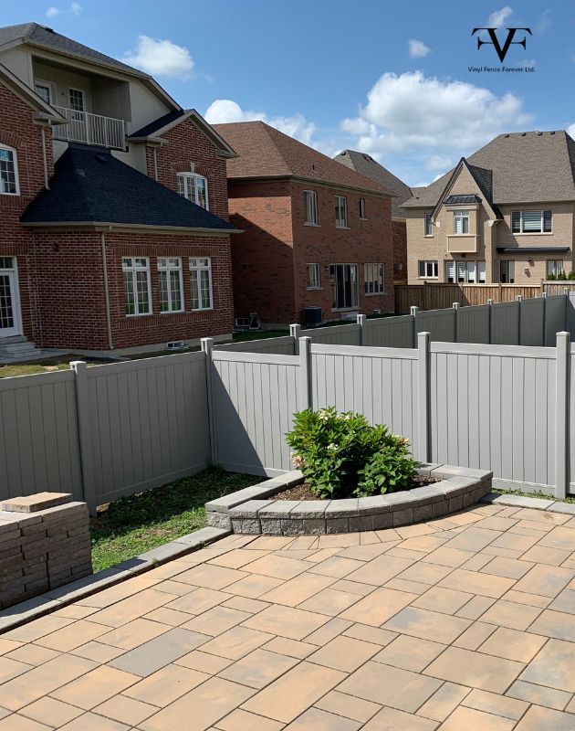 backyard grey vinyl fence installation in aurora